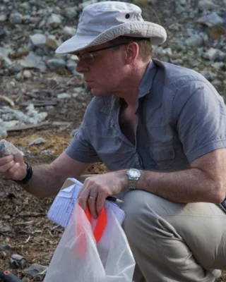 Glenn examining sample